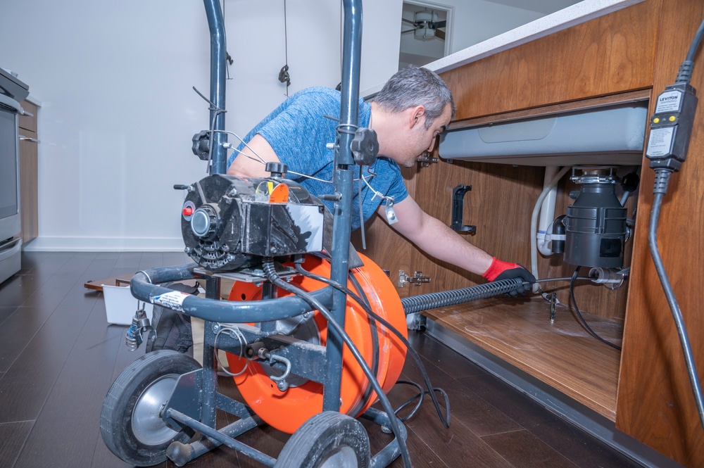 Plumber,Drain,Cleaning,A,Kitchen,Sink,Inside,A,Residential,Home