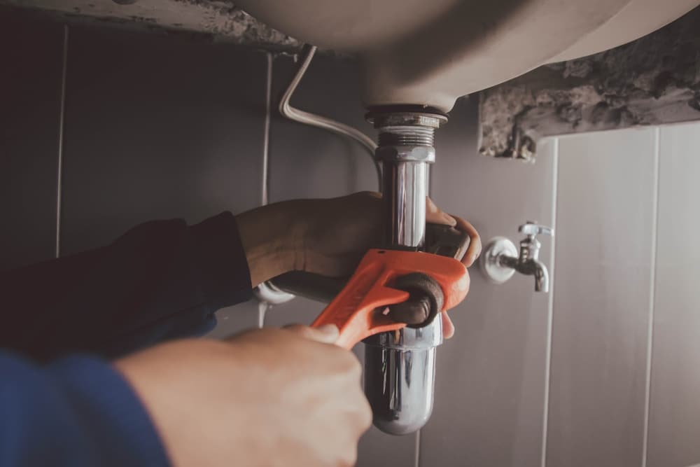 Plumber,At,Work,In,A,Bathroom,,Plumbing,Repair,Service,,